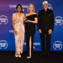 Image caption: Sirini Griffiths and Ellen Valvasori receiving the award, with Alexander Roche from Androgogic